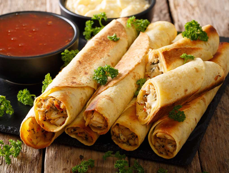 Plate of several oven backed chicken taquitos for diabetics