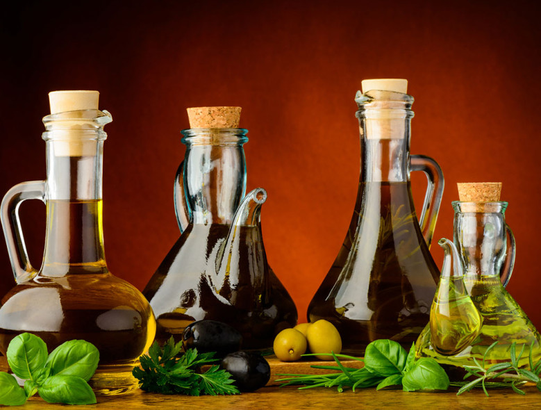 Bottles of olive oil filled with herbs