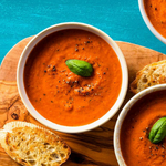 Cup of low carb diabetic tomato basil soup topped with basil leaf
